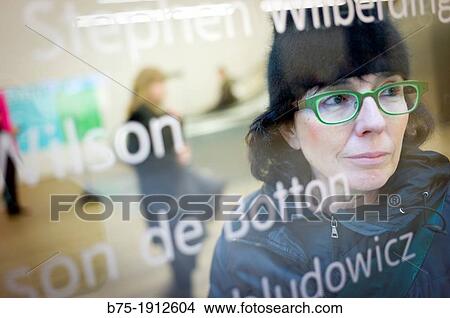 young woman looking through a window inside in Tate Modern, South Bank, London, England, UK View Large Photo Image Picture - young woman looking through a window inside in Tate Modern, South Bank, London, England, UK. Fotosearch