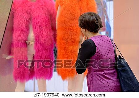 young woman looks at fashion windows in city center View Large Photo Image Stock Image - young woman looks at fashion windows in city center. Fotosearch