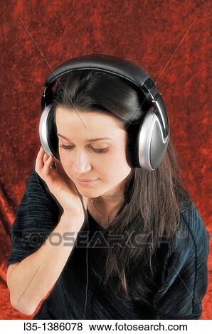 Young woman looks dreamy with headphones View Large Photo Image Stock Photo - Young woman looks dreamy with headphones. Fotosearch