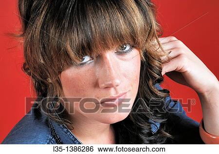 Young woman looks thoughtfully at the camera View Large Photo Image Stock Photograph - Young woman looks thoughtfully at the camera. Fotosearch
