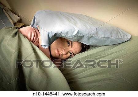 Young woman lying in bed View Large Photo Image Stock Image - Young woman lying in bed. Fotosearch