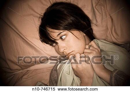 Young woman lying in bed. View Large Photo Image Stock Photography - Young woman lying in bed.. Fotosearch