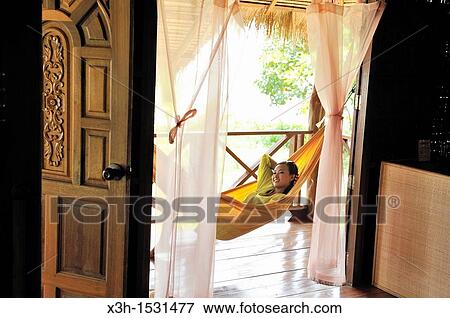 Young woman lying in hammock, Koh Jum Lodge, Koh Jum Island, Krabi, Thailand, Asia View Large Photo Image Stock Photo - Young woman lying in hammock, Koh Jum Lodge, Koh Jum Island, Krabi, Thailand, Asia. Fotosearch
