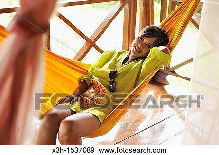 Stock Photo - Young woman lying in hammock, Koh Jum Lodge, Koh Jum Island, Krabi, Thailand, Asia. Fotosearch