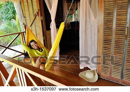Stock Photo - Young woman lying in hammock, Koh Jum Lodge, Koh Jum Island, Krabi, Thailand, Asia. Fotosearch