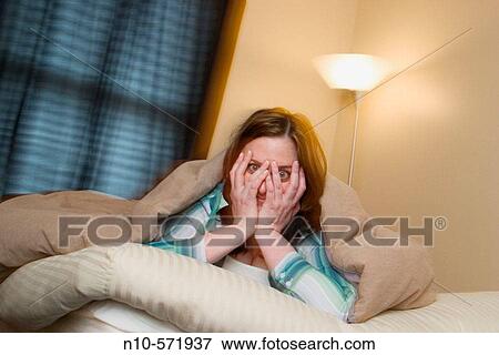 Young woman lying on the bed in her bedroom View Large Photo Image Stock Photo - Young woman lying on the bed in her bedroom. Fotosearch