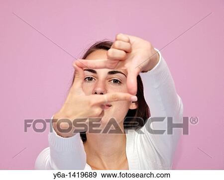 Young woman making finger frame View Large Photo Image Stock Photo - Young woman making finger frame. Fotosearch
