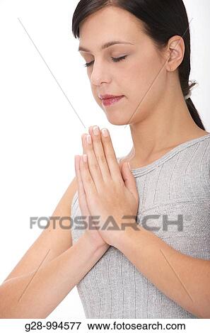 young woman meditating with hands together and eyes shut View Large Photo Image Stock Photo - young woman meditating with hands together and eyes shut. Fotosearch