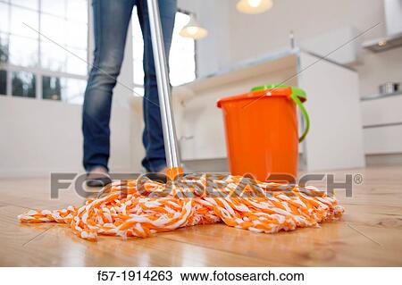 Young woman mopping her kitchen floor View Large Photo Image Stock Image - Young woman mopping her kitchen floor. Fotosearch