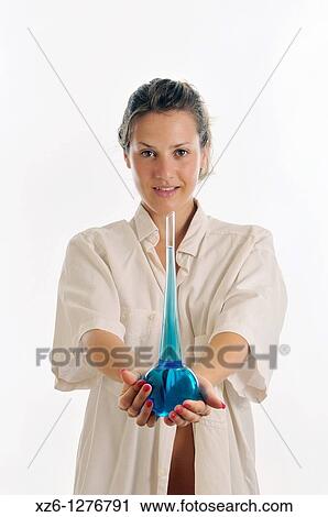Young woman offering suggestive blue liquid View Large Photo Image Stock Image - Young woman offering suggestive blue liquid. Fotosearch