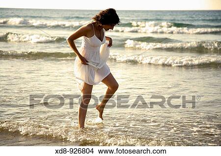 young woman on a beach View Large Photo Image Picture - young woman on a beach. Fotosearch