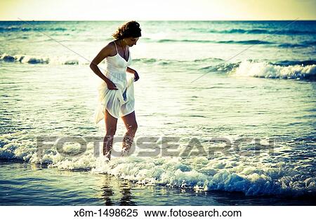 Stock Photography - Young woman on a beach. Fotosearch