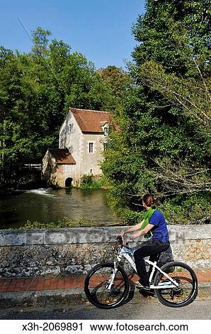 young woman on a bridge in front of a Water mill on the Huisne River bank at Dorceau, Orne department, Lower Normandy region, France, Western Europe. View Large Photo Image Stock Image - young woman on a bridge in front of a Water mill on the Huisne River bank at Dorceau, Orne department, Lower Normandy region, France, Western Europe.. Fotosearch