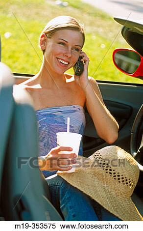 Young woman on a convertible View Large Photo Image Stock Photography - Young woman on a convertible. Fotosearch