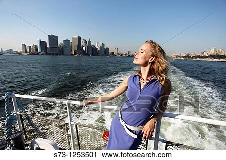 Stock Image - Young woman on a ferryboat, Manhattan, New York, USA. Fotosearch