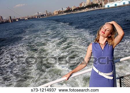 Young woman on a ferryboat, Manhattan, New York, USA View Large Photo Image Stock Photo - Young woman on a ferryboat, Manhattan, New York, USA. Fotosearch