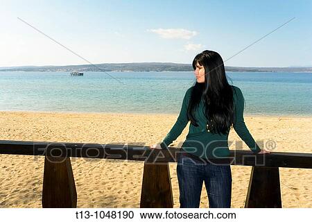 Young woman on an empty beach before Summer View Large Photo Image Stock Image - Young woman on an empty beach before Summer. Fotosearch