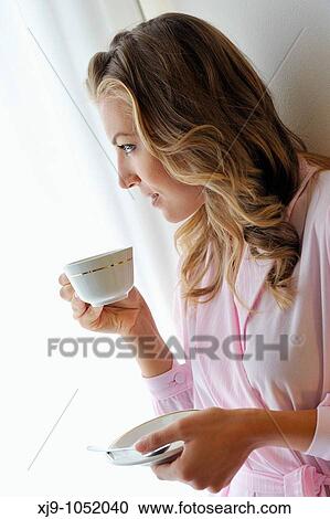 Young woman on bed in hotel room View Large Photo Image Stock Image - Young woman on bed in hotel room. Fotosearch