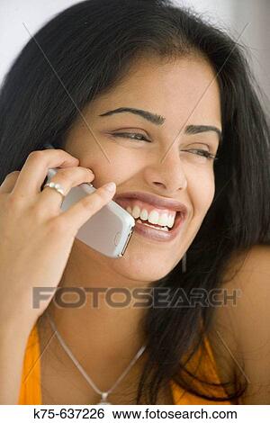 Young woman on cell phone View Large Photo Image Stock Photograph - Young woman on cell phone. Fotosearch