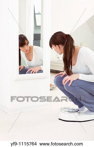 Young woman on scale. View Large Photo Image Picture - Young woman on scale.. Fotosearch