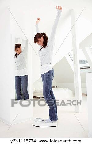 Young woman on scale. View Large Photo Image Picture - Young woman on scale.. Fotosearch