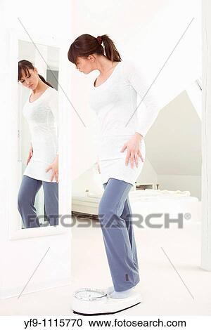 Young woman on scale. View Large Photo Image Stock Image - Young woman on scale.. Fotosearch