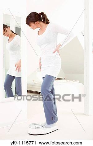 Young woman on scale. View Large Photo Image Stock Image - Young woman on scale.. Fotosearch