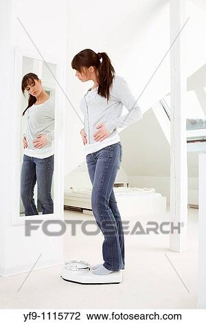 Young woman on scale. View Large Photo Image Stock Image - Young woman on scale.. Fotosearch