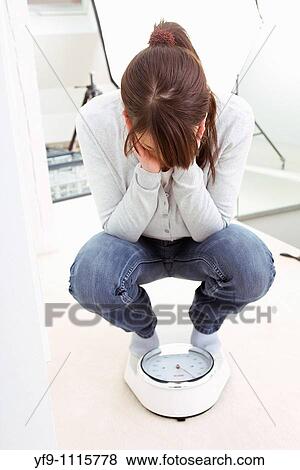 Young woman on scale. View Large Photo Image Stock Photo - Young woman on scale.. Fotosearch