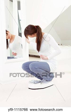 Young woman on scale. View Large Photo Image Stock Photograph - Young woman on scale.. Fotosearch