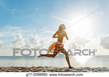 Young woman on the beach, Miami Beach, Florida, USA View Large Photo Image Stock Image - Young woman on the beach, Miami Beach, Florida, USA. Fotosearch