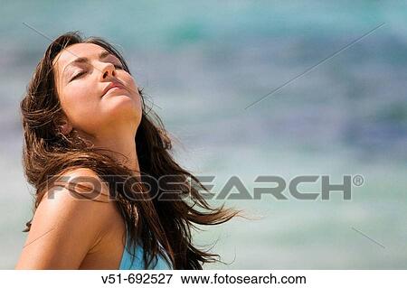 Young woman on the beach on sunbathing View Large Photo Image Stock Photo - Young woman on the beach on sunbathing. Fotosearch
