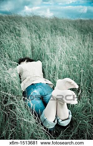 young woman on the grass View Large Photo Image Stock Image - young woman on the grass. Fotosearch