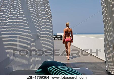 young woman on the spa terrace of the Almyra Luxury Spa Hotel, Paphos, Cyprus, Eastern Mediterranean Sea View Large Photo Image Picture - young woman on the spa terrace of the Almyra Luxury Spa Hotel, Paphos, Cyprus, Eastern Mediterranean Sea. Fotosearch