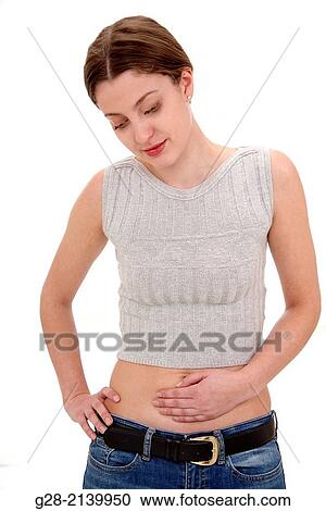Young woman, one hand on her stomach for pain, and one hand on her hip View Large Photo Image Stock Image - Young woman, one hand on her stomach for pain, and one hand on her hip. Fotosearch