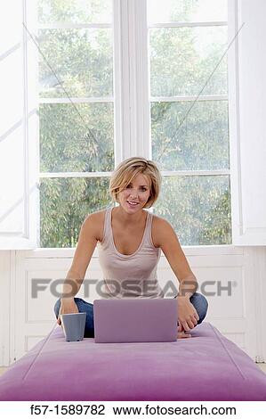 Young woman online View Large Photo Image Stock Image - Young woman online. Fotosearch