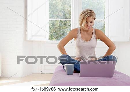 Stock Photograph - Young woman online. Fotosearch