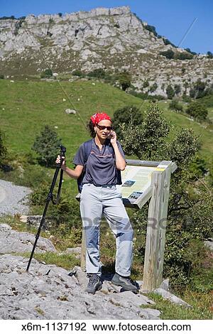 young woman outdoor with a cellphone Los Collados del Ason Natural Park Cantabria, Spain, Europe View Large Photo Image Stock Image - young woman outdoor with a cellphone Los Collados del Ason Natural Park Cantabria, Spain, Europe. Fotosearch