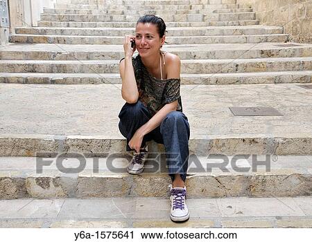 Young woman outdoors using cell phone View Large Photo Image Stock Image - Young woman outdoors using cell phone. Fotosearch
