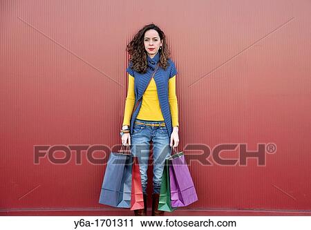 Stock Image - Young woman outdoors with shopping bags. Fotosearch