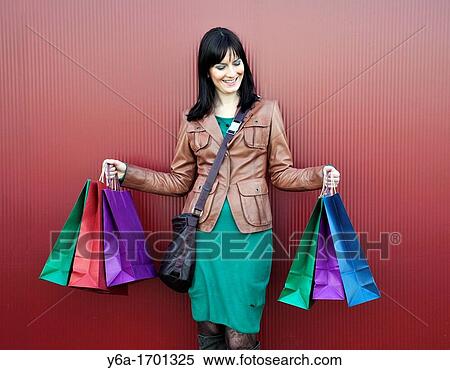 Young woman outdoors with shopping bags View Large Photo Image Stock Photography - Young woman outdoors with shopping bags. Fotosearch