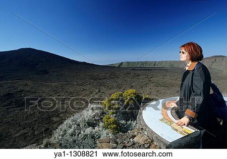 Young woman overlooking Piton de la Fournaise volcano and caldera Enclos Fouque from Pas de Bellecombe, La Reunion island (France), Indian Ocean View Large Photo Image Stock Image - Young woman overlooking Piton de la Fournaise volcano and caldera Enclos Fouque from Pas de Bellecombe, La Reunion island (France), Indian Ocean. Fotosearch