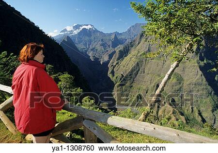 Young woman overlooking Riviere des Galets valley and back Cirque de Mafate with Piton des Neiges peak, viewed from Dos d? Ane, La Reunion island (France), Indian Ocean View Large Photo Image Stock Image - Young woman overlooking Riviere des Galets valley and back Cirque de Mafate with Piton des Neiges peak, viewed from Dos d? Ane, La Reunion island (France), Indian Ocean. Fotosearch