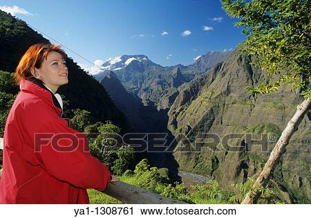 Young woman overlooking Riviere des Galets valley and back Cirque de Mafate with Piton des Neiges peak, viewed from Dos d? Ane, La Reunion island (France), Indian Ocean View Large Photo Image Stock Image - Young woman overlooking Riviere des Galets valley and back Cirque de Mafate with Piton des Neiges peak, viewed from Dos d? Ane, La Reunion island (France), Indian Ocean. Fotosearch