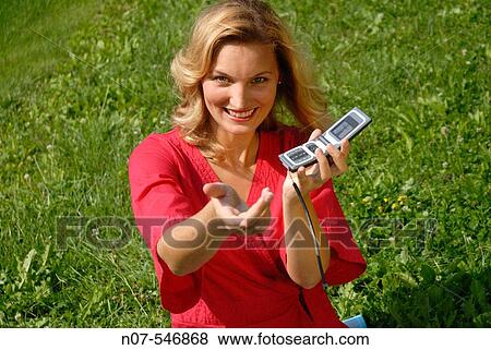 Stock Photo - Young woman passing a phone call. Fotosearch