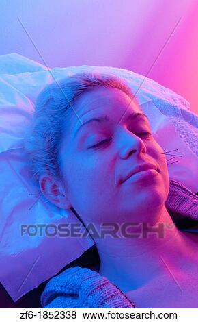 Young woman patient of acupunture getting ear and face needles treatment for pain and allergies View Large Photo Image Stock Photo - Young woman patient of acupunture getting ear and face needles treatment for pain and allergies. Fotosearch