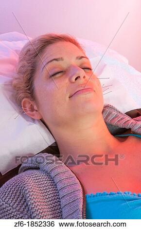 Young woman patient of acupunture getting ear and face needles treatment for pain and allergies View Large Photo Image Stock Photograph - Young woman patient of acupunture getting ear and face needles treatment for pain and allergies. Fotosearch