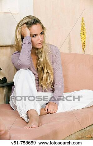 Young woman, pensive, couch View Large Photo Image Stock Photo - Young woman, pensive, couch. Fotosearch
