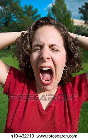 Young woman performing an odd behavior View Large Photo Image Stock Photo - Young woman performing an odd behavior. Fotosearch
