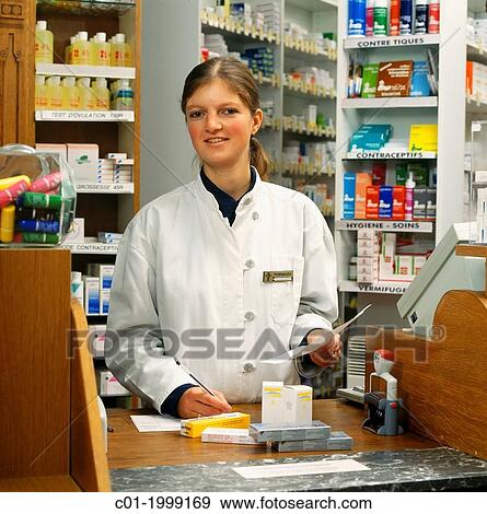 Young woman pharmacist filling a prescription. View Large Photo Image Stock Photo - Young woman pharmacist filling a prescription.. Fotosearch